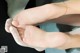 A close up of a person's feet with a gold bracelet.