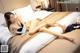 A woman laying on top of a bed in a hotel room.