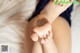 A close up of a woman's feet on a bed.