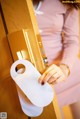 A woman is opening a door with a do not disturb sign.