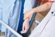 A nurse holding the hand of a patient in a hospital bed.