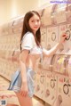 A woman in a school uniform standing in front of a vending machine.