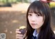 A young woman holding a sweet potato in her hand.