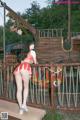 A woman in a red and white bikini standing on a bridge.