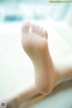 A close up of a person's bare foot on a window sill.